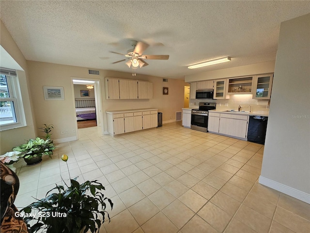 2221 Norwegian Dr Unit 15, Clearwater, FL 33763 - kitchen with stainless steel electric stove, dishwasher, light countertops, a sink, and light tile patterned flooring