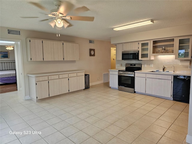 2221 Norwegian Dr Unit 15, Clearwater, FL 33763 - kitchen featuring appliances with stainless steel finishes, light countertops, a sink, decorative backsplash, and a textured ceiling