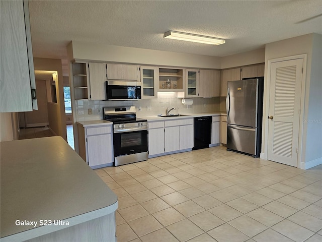 2221 Norwegian Dr Unit 15, Clearwater, FL 33763 - kitchen with appliances with stainless steel finishes, a sink, open shelves, light countertops, and a textured ceiling