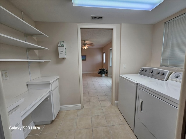 2221 Norwegian Dr Unit 15, Clearwater, FL 33763 - washroom with washing machine and dryer, light tile patterned floors, baseboards, cabinet space, and ceiling fan