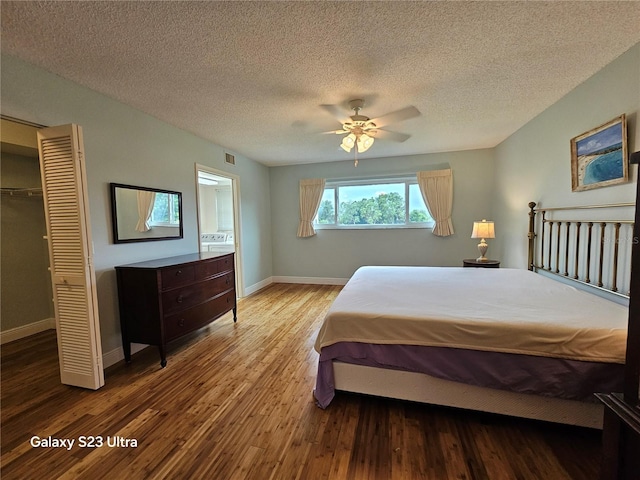 2221 Norwegian Dr Unit 15, Clearwater, FL 33763 - bedroom featuring wood finished floors, baseboards, a textured ceiling, a ceiling fan, and a closet