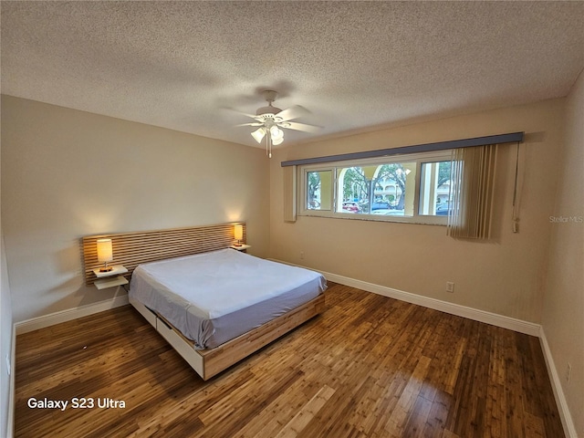 2221 Norwegian Dr Unit 15, Clearwater, FL 33763 - bedroom with baseboards, hardwood / wood-style flooring, a textured ceiling, and a ceiling fan