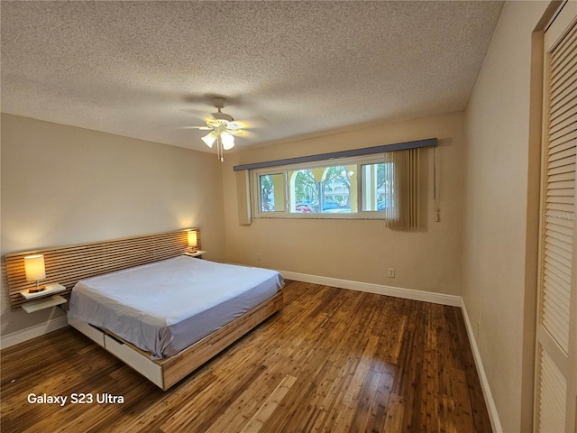 2221 Norwegian Dr Unit 15, Clearwater, FL 33763 - bedroom featuring hardwood / wood-style floors, baseboards, a closet, a ceiling fan, and a textured ceiling