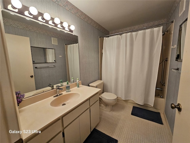 2221 Norwegian Dr Unit 15, Clearwater, FL 33763 - bathroom featuring vanity, toilet, shower / bath combo, tile patterned flooring, and wallpapered walls