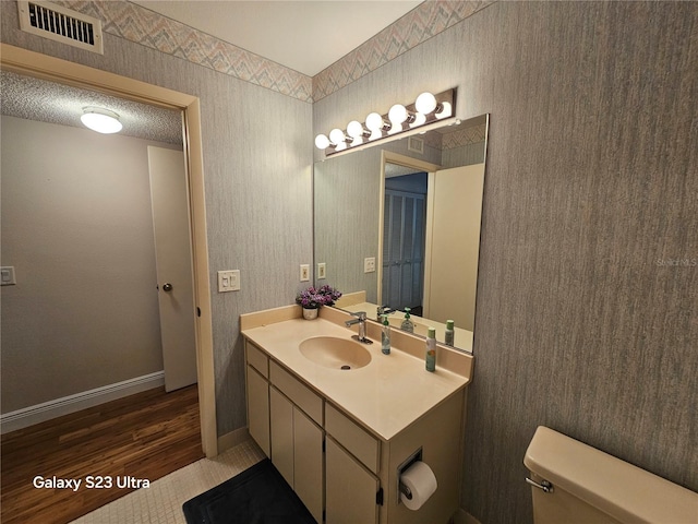 2221 Norwegian Dr Unit 15, Clearwater, FL 33763 - bathroom with vanity, toilet, baseboards, and wood finished floors