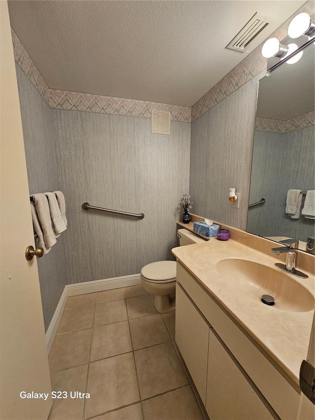 2221 Norwegian Dr Unit 15, Clearwater, FL 33763 - bathroom with vanity, tile patterned flooring, toilet, a textured ceiling, and baseboards