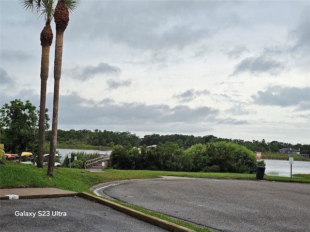 2221 Norwegian Dr Unit 15, Clearwater, FL 33763 - view of asphalt street with a water view and curbs