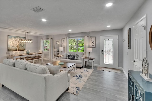 8222 Valrie Ln, Riverview, FL 33569 - living area featuring recessed lighting, baseboards, a textured ceiling, a chandelier, and wood finished floors