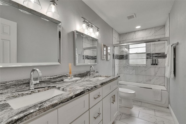8222 Valrie Ln, Riverview, FL 33569 - bathroom with marble look tiles, toilet, shower / bath combination with glass door, double vanity, and baseboards