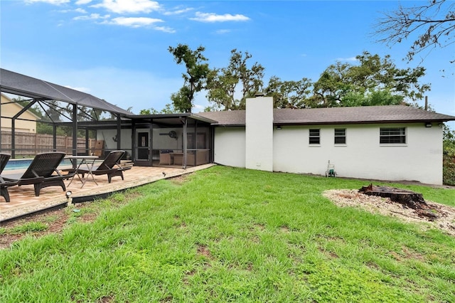 8222 Valrie Ln, Riverview, FL 33569 - rear view of house with a chimney, a lawn, a patio area, and stucco siding