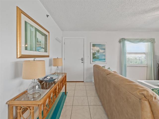 18610 Gulf Blvd Unit 208, Indian Shores, FL 33785 - living area with a textured ceiling, light tile patterned floors, and baseboards