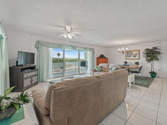 18610 Gulf Blvd Unit 208, Indian Shores, FL 33785 - living area featuring a chandelier, a ceiling fan, light tile patterned flooring, and a textured ceiling