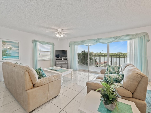 18610 Gulf Blvd Unit 208, Indian Shores, FL 33785 - living area with light tile patterned floors, a ceiling fan, and a textured ceiling