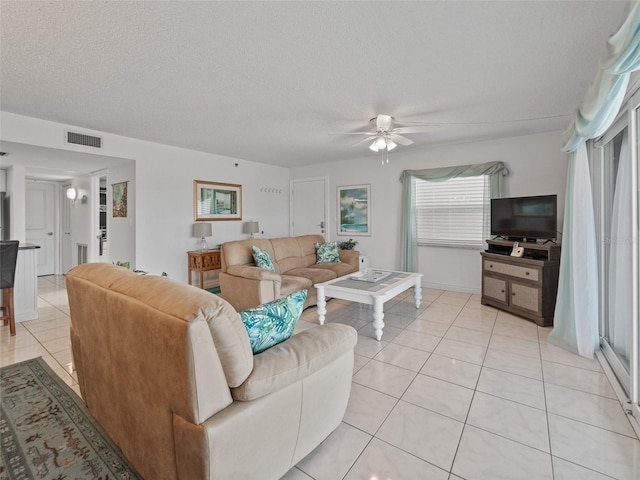 18610 Gulf Blvd Unit 208, Indian Shores, FL 33785 - living area with light tile patterned floors, a ceiling fan, and a textured ceiling