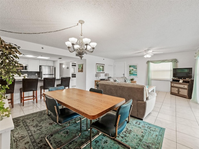 18610 Gulf Blvd Unit 208, Indian Shores, FL 33785 - dining area with light tile patterned floors, a chandelier, a textured ceiling, and ceiling fan