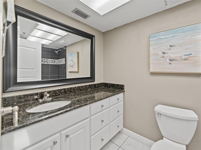 18610 Gulf Blvd Unit 208, Indian Shores, FL 33785 - full bathroom with tiled shower, vanity, toilet, baseboards, and tile patterned flooring