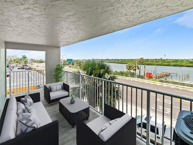 18610 Gulf Blvd Unit 208, Indian Shores, FL 33785 - balcony featuring a water view and outdoor lounge area