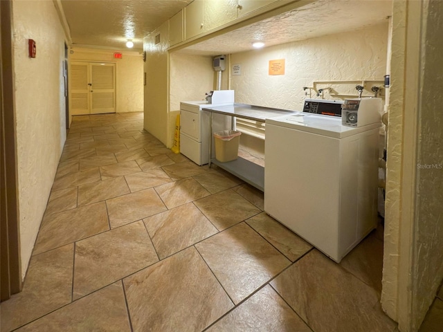 18610 Gulf Blvd Unit 208, Indian Shores, FL 33785 - shared laundry room featuring a textured wall, washer and dryer, and a textured ceiling