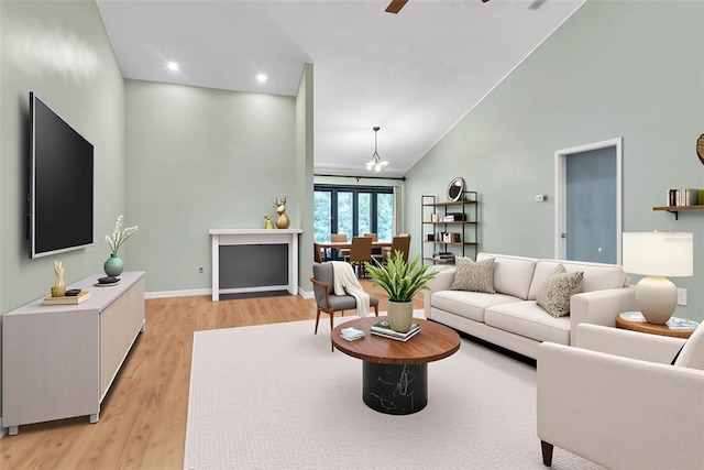 2640 Enterprise Rd E Unit B25, Clearwater, FL 33759 - living area with light wood finished floors, ceiling fan, high vaulted ceiling, recessed lighting, and baseboards