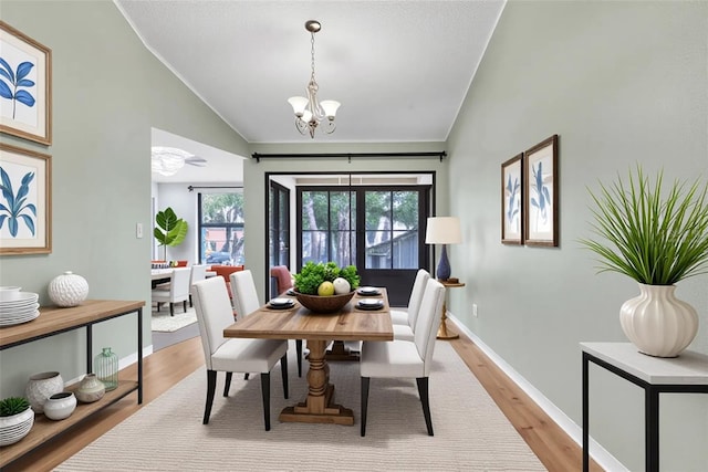 2640 Enterprise Rd E Unit B25, Clearwater, FL 33759 - dining area with lofted ceiling, a chandelier, light wood finished floors, and baseboards