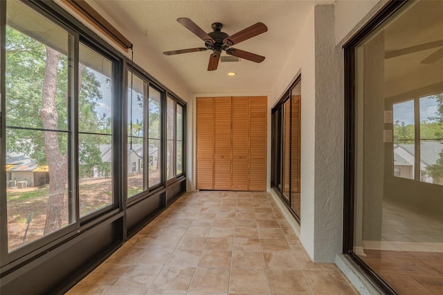 2640 Enterprise Rd E Unit B25, Clearwater, FL 33759 - unfurnished sunroom featuring a ceiling fan, a textured wall, tile patterned flooring, and recessed lighting