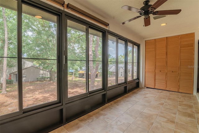 2640 Enterprise Rd E Unit B25, Clearwater, FL 33759 - unfurnished sunroom featuring ceiling fan, tile patterned flooring, and recessed lighting