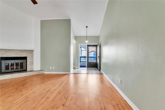 2640 Enterprise Rd E Unit B25, Clearwater, FL 33759 - unfurnished living room with wood finished floors, baseboards, a fireplace, and ceiling fan