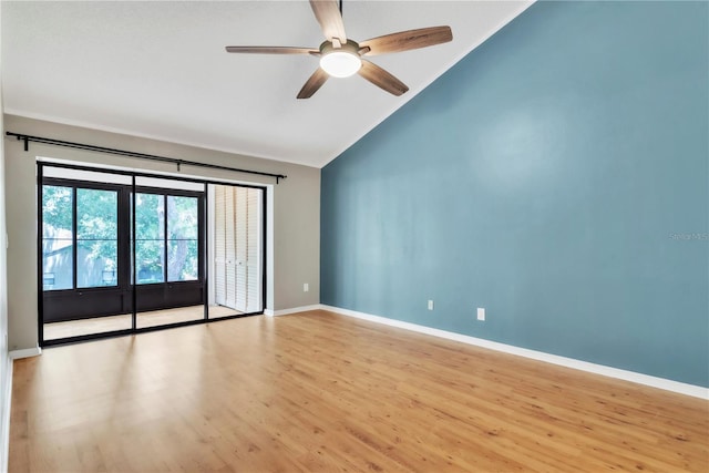 2640 Enterprise Rd E Unit B25, Clearwater, FL 33759 - empty room with a ceiling fan, wood finished floors, baseboards, and high vaulted ceiling