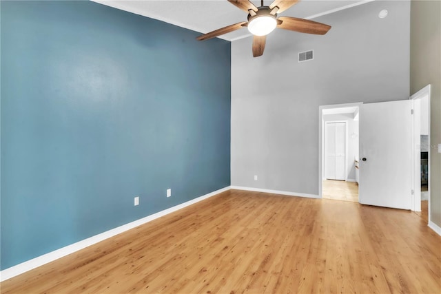 2640 Enterprise Rd E Unit B25, Clearwater, FL 33759 - spare room featuring a high ceiling, ceiling fan, light wood-style floors, and baseboards