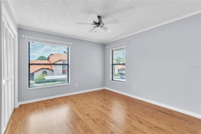 2640 Enterprise Rd E Unit B25, Clearwater, FL 33759 - unfurnished room featuring a textured ceiling, light wood-style flooring, a ceiling fan, and baseboards