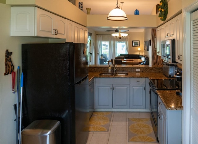 10188 Regent Cir Unit 2802, Naples, FL 34109 - kitchen featuring black appliances, light tile patterned floors, a ceiling fan, a sink, and white cabinetry