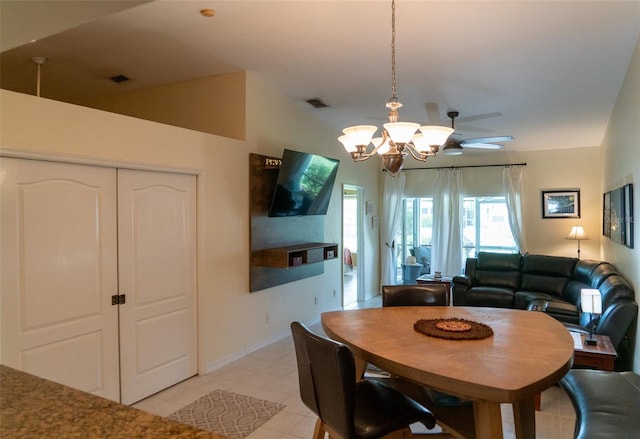 10188 Regent Cir Unit 2802, Naples, FL 34109 - dining area with ceiling fan, a chandelier, and light tile patterned floors