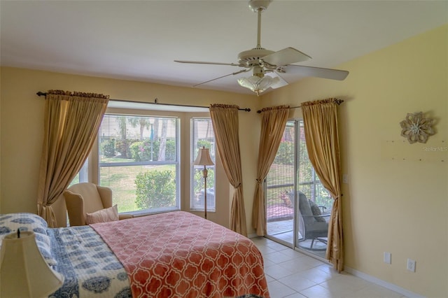 10188 Regent Cir Unit 2802, Naples, FL 34109 - bedroom with access to exterior, light tile patterned floors, ceiling fan, and baseboards