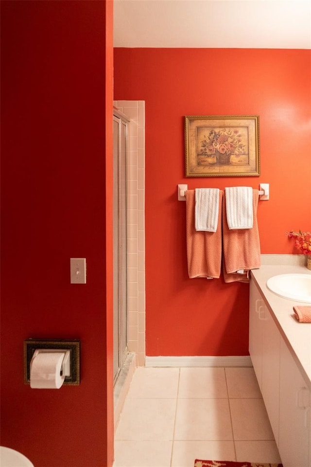 10188 Regent Cir Unit 2802, Naples, FL 34109 - bathroom with tile patterned floors, a shower stall, vanity, baseboards, and toilet
