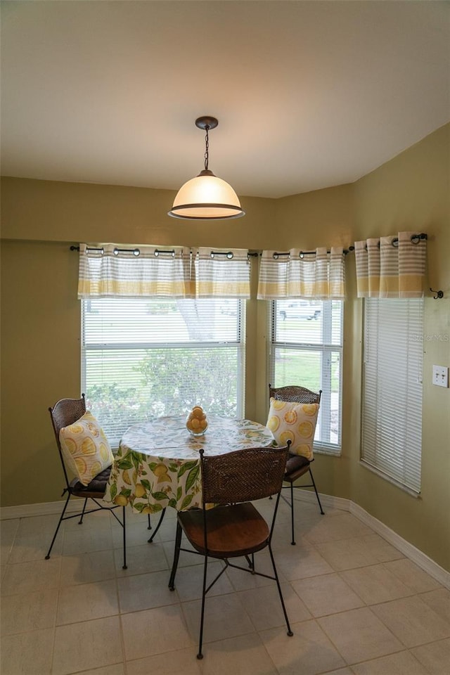 10188 Regent Cir Unit 2802, Naples, FL 34109 - dining room featuring baseboards and light tile patterned floors
