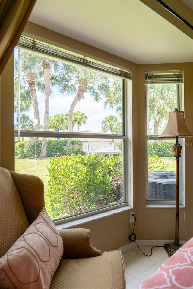 10188 Regent Cir Unit 2802, Naples, FL 34109 - bedroom with light tile patterned floors, multiple windows, and baseboards