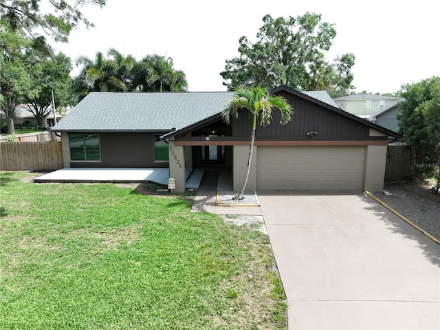 11525 Country Oaks Dr, Tampa, FL 33618 - view of front of home with a garage, driveway, and a shingled roof