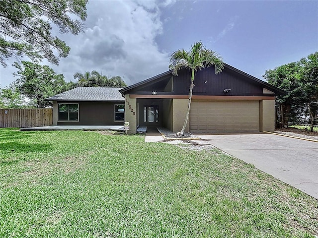 11525 Country Oaks Dr, Tampa, FL 33618 - view of front of property with a garage, concrete driveway, and stucco siding