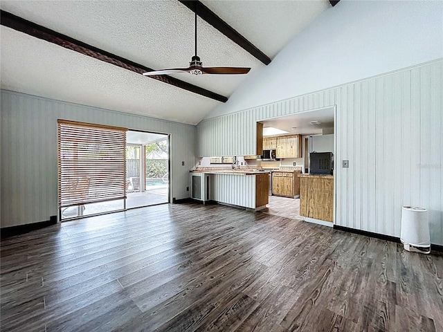 11525 Country Oaks Dr, Tampa, FL 33618 - unfurnished living room featuring dark wood-style flooring, beam ceiling, ceiling fan, a textured ceiling, and wood walls