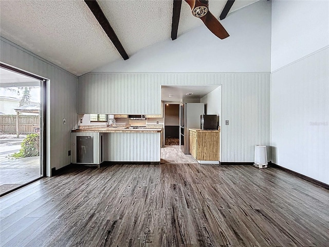 11525 Country Oaks Dr, Tampa, FL 33618 - unfurnished living room with ceiling fan, dark wood-style flooring, beam ceiling, a textured ceiling, and high vaulted ceiling