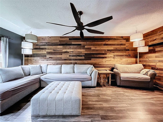 11525 Country Oaks Dr, Tampa, FL 33618 - living area featuring a ceiling fan, wooden walls, a textured ceiling, and hardwood / wood-style floors