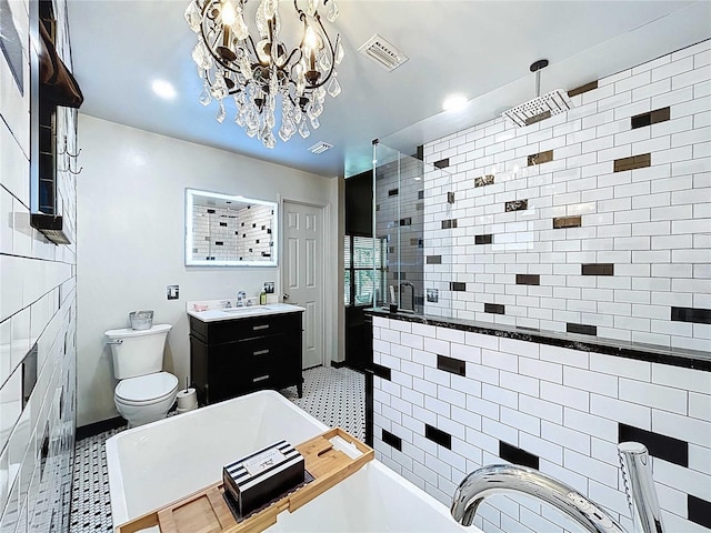 11525 Country Oaks Dr, Tampa, FL 33618 - full bathroom featuring a freestanding tub, a stall shower, toilet, a chandelier, and vanity