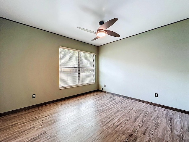 11525 Country Oaks Dr, Tampa, FL 33618 - empty room with wood finished floors, ceiling fan, and baseboards