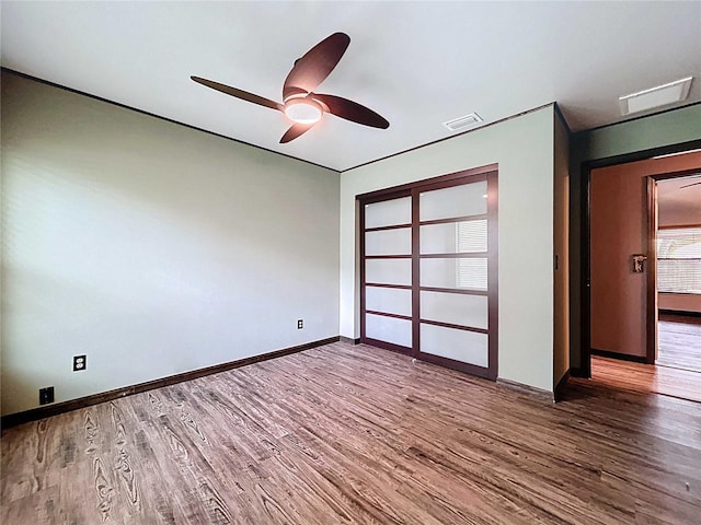 11525 Country Oaks Dr, Tampa, FL 33618 - unfurnished bedroom featuring wood finished floors, baseboards, a closet, and ceiling fan