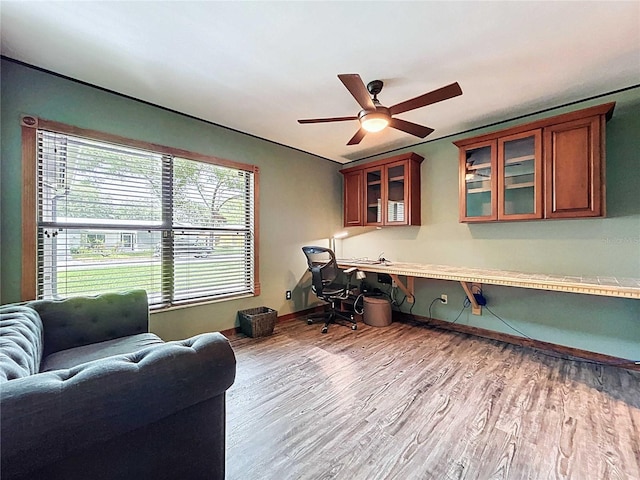 11525 Country Oaks Dr, Tampa, FL 33618 - home office with wood finished floors, ceiling fan, baseboards, and built in study area