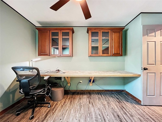 11525 Country Oaks Dr, Tampa, FL 33618 - office area featuring built in desk, a ceiling fan, baseboards, and wood finished floors