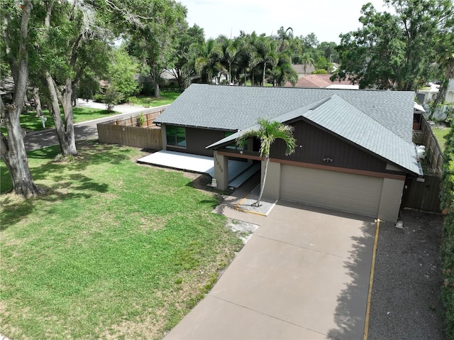 11525 Country Oaks Dr, Tampa, FL 33618 - mid-century home with a shingled roof, a garage, and driveway