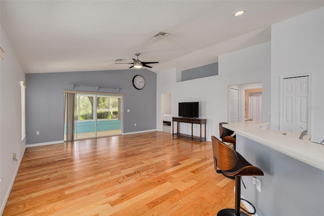 11078 Heathrow Ave, Spring Hill, FL 34609 - living room with lofted ceiling, ceiling fan, light wood-type flooring, baseboards, and recessed lighting