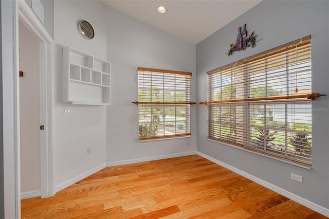 11078 Heathrow Ave, Spring Hill, FL 34609 - empty room with lofted ceiling, wood finished floors, and baseboards