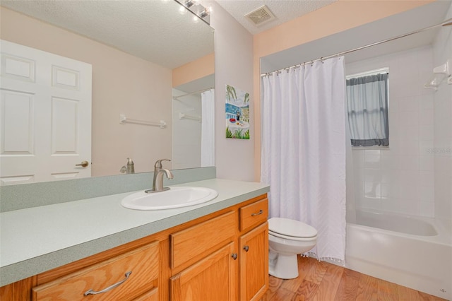 11078 Heathrow Ave, Spring Hill, FL 34609 - full bath with vanity, a textured ceiling, wood finished floors, toilet, and shower / tub combo with curtain